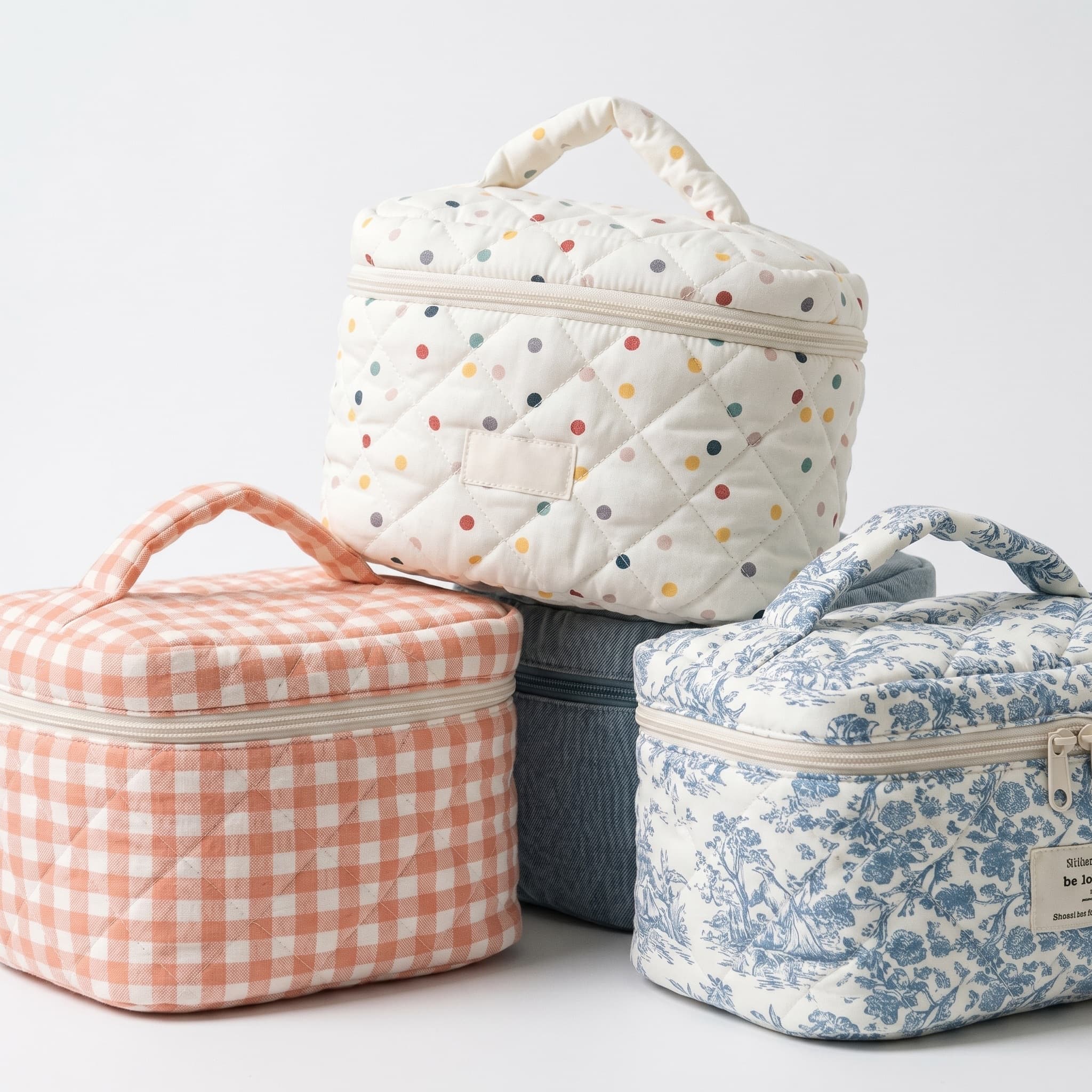 Production surplus: quilted cotton vanity cases in polka dot, gingham and toile prints.